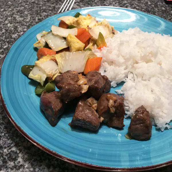 Marinated Steak Tips served with rice and sauteed veggies.
