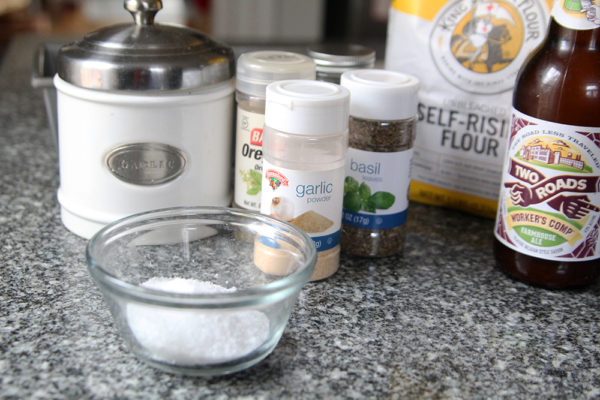Ingredients for this no-knead bread recipe, a quick bread with self-rising flour, are shown on a granite countertop.