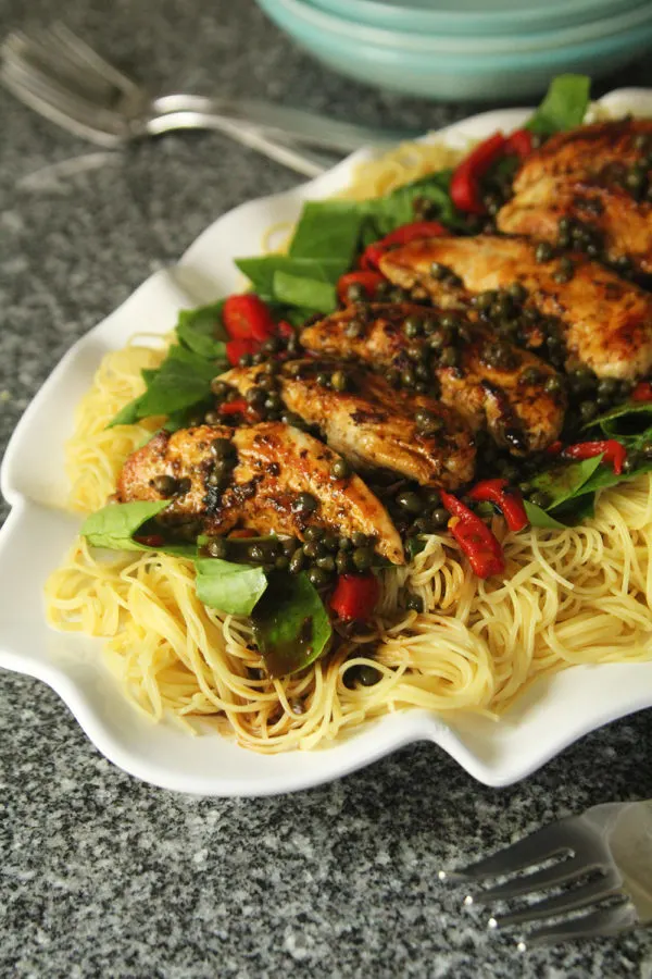 A lemony pasta sauce tops angel hair with chicken, spinach, roasted red peppers and capers.