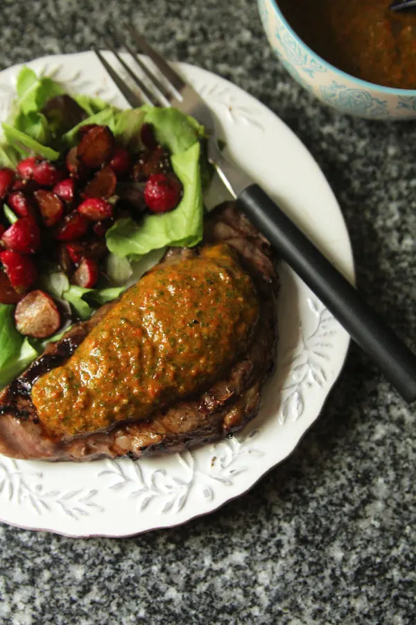 Roasted Red Pepper, Radish Greens and Garlic Sauce uses the edible tops of radishes to make a delectable sauce. Here it is served on steak with a salad featuring balsamic sauteed radishes. 