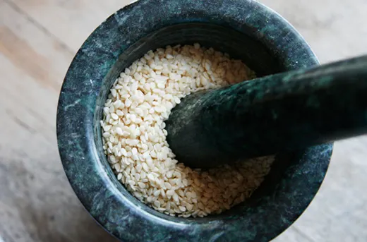 sesame seeds in a mortar and pestle.