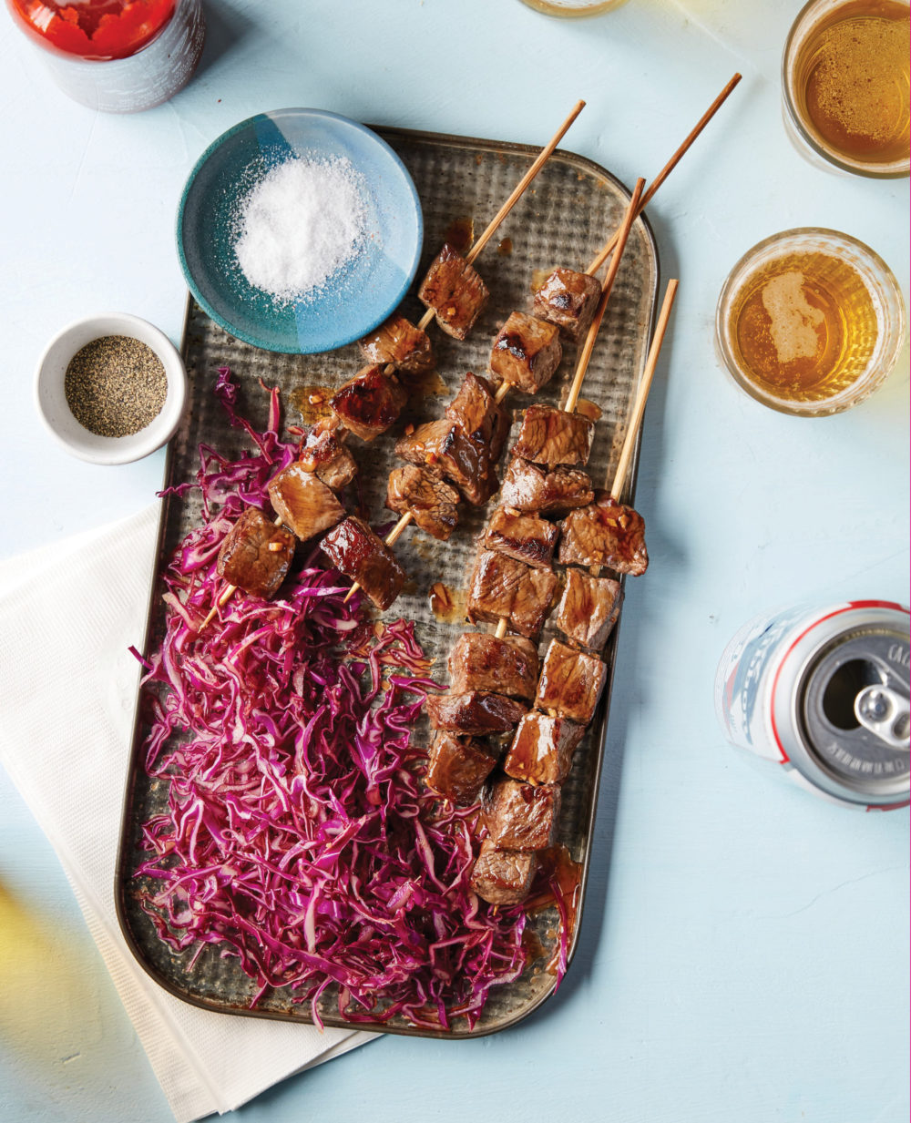 A tray holds Hoisin Beef Skewers with Gingery Red Cabbage Slaw.