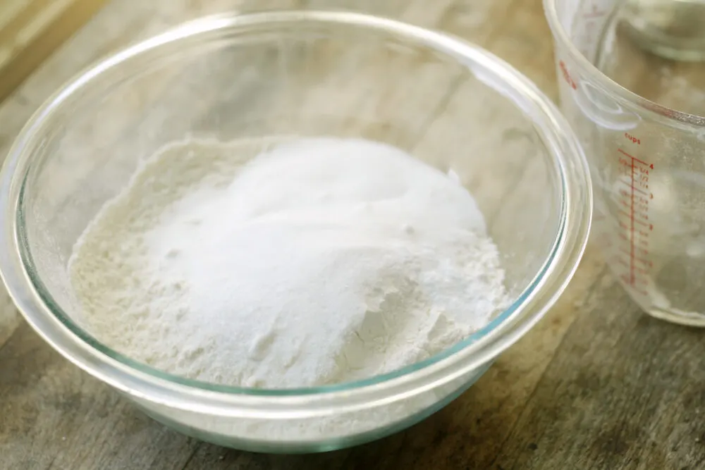 Dry ingredients like flour, sugar and salt are shown in a mixing bowl.