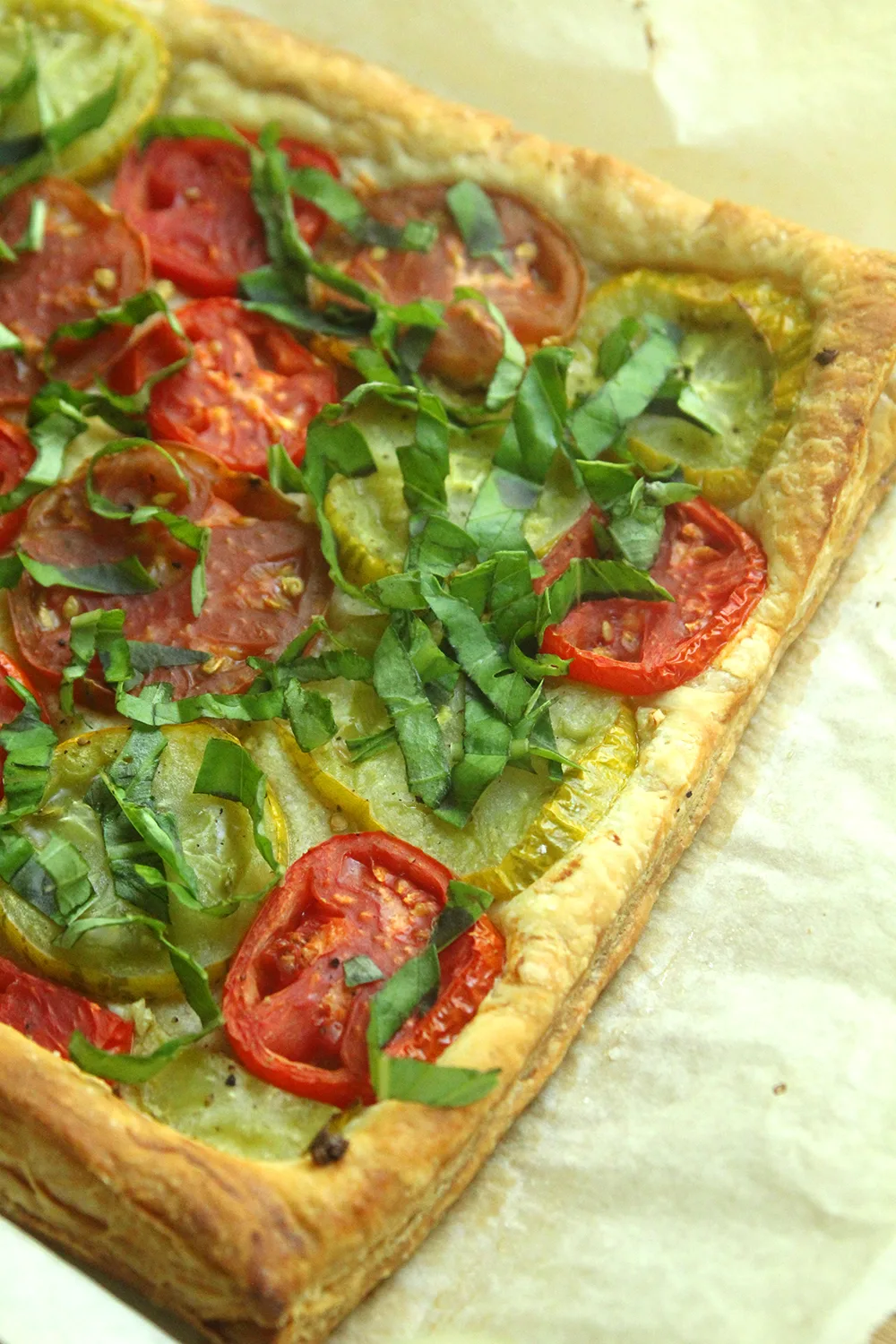 Fresh tomatoes, garlic, olive oil and wisps of basil make this flaky, sweet, bright Tomato Basil Tart brilliant. And it's easy to make!
