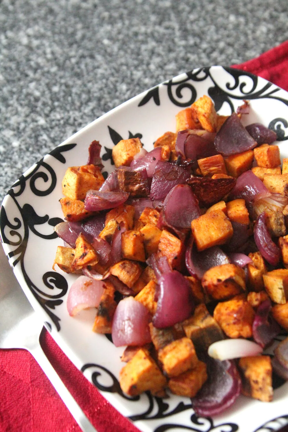 A plate of Roasted Sweet Potatoes and Red Onions with Gochujang Seasoning.