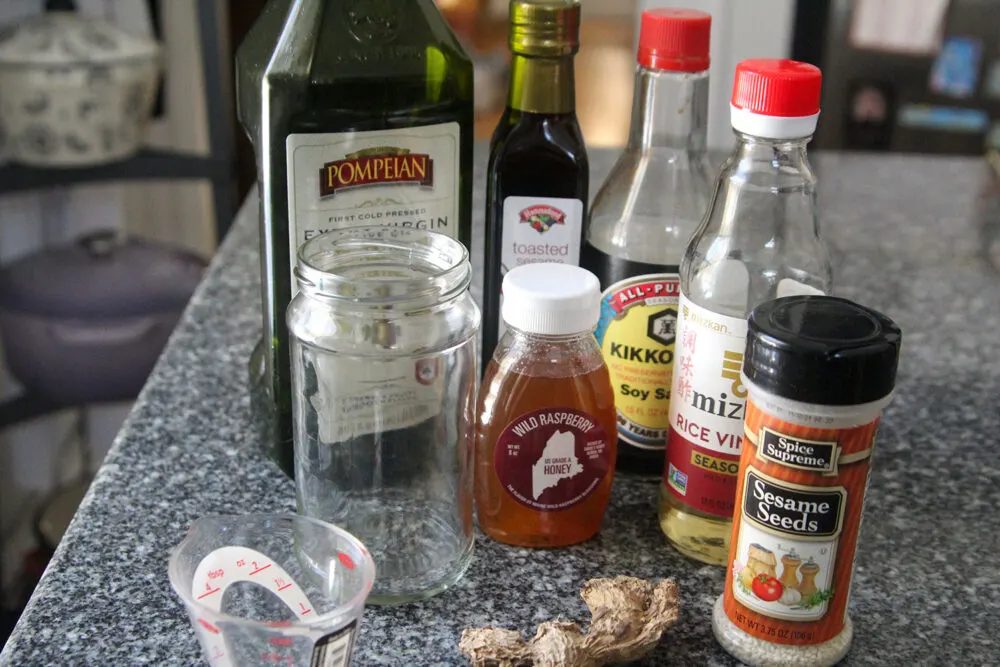 Ingredients for Sesame Ginger Dressing are shown on a granite countertop.