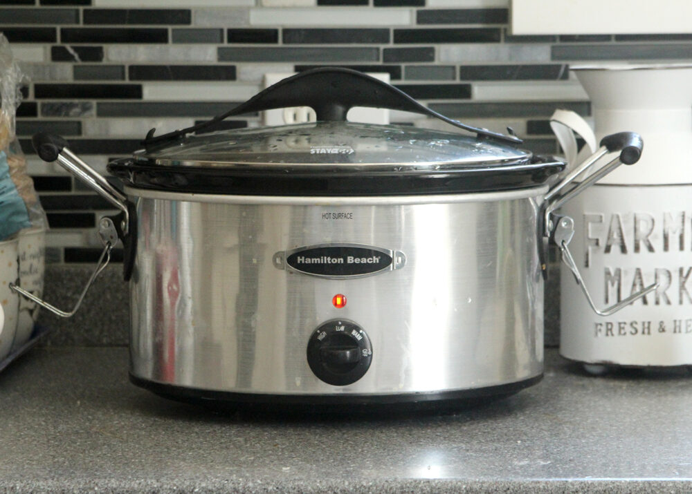 A slow cooker sits on a counter.