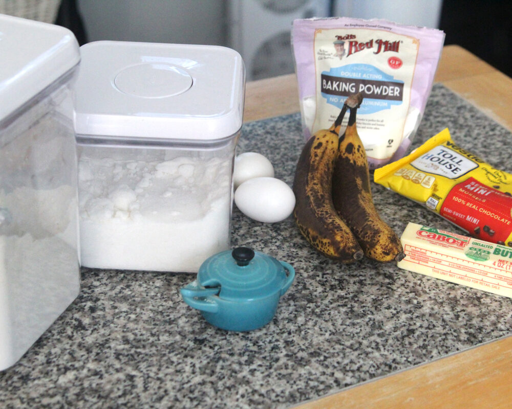 Ingredients for banana muffins are spread out on a counter.