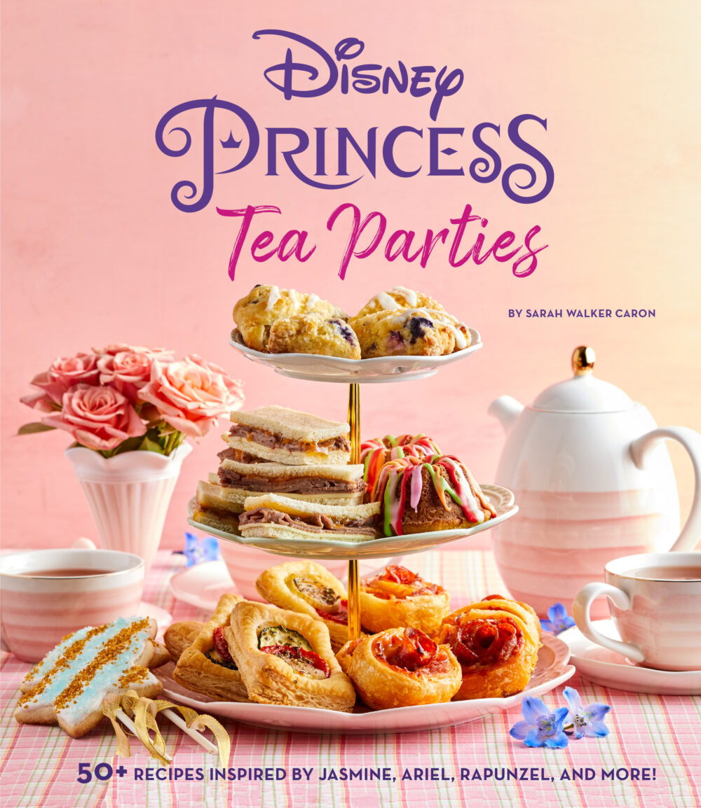 The cover of a cookbook with the title Disney Princess Tea Parties is shown. The cover is predominantly pink and has a tiered tray with scones, sandwiches, and parties on it. A vase with roses, a tea pot and tea cups sit nearby.